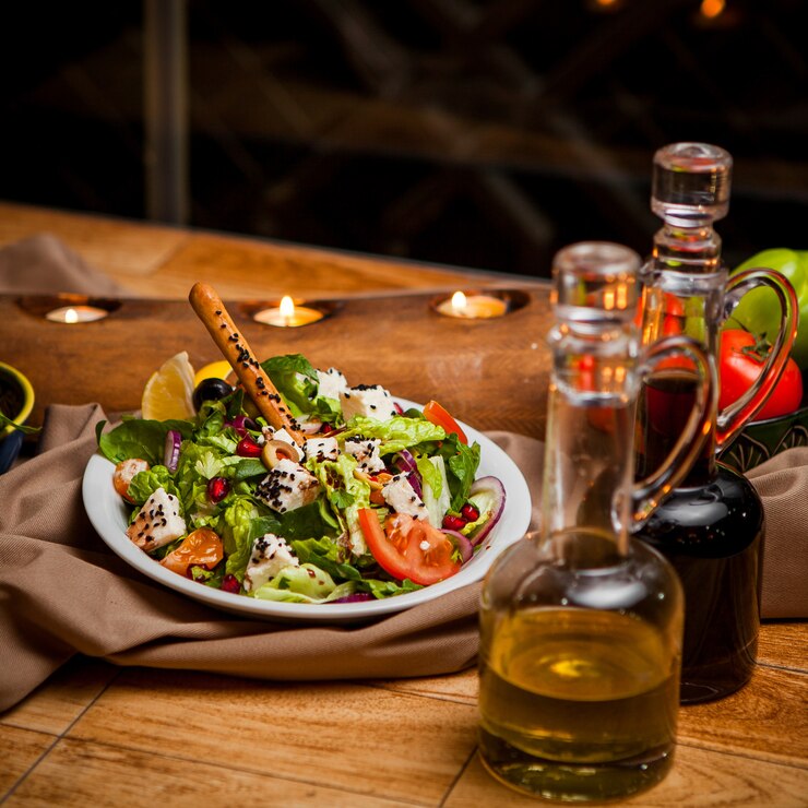 side view greek salad with olive oil soy sauce candles round white plate 176474 3108